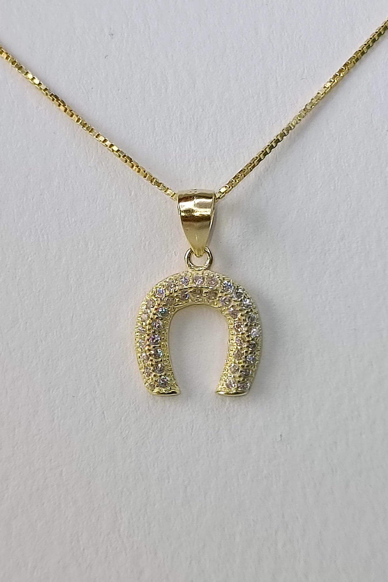Horseshoe bombe' necklace in gold plated 925 silver and pavé workmanship.